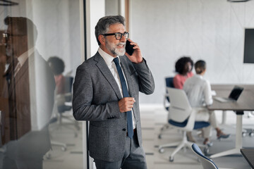 Senior businessman talking on smartphone in modern office