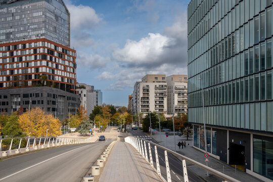 Modern Paris urban street architecture with bridge skyline buildings under autumn clouds creating wide city avenue travel background