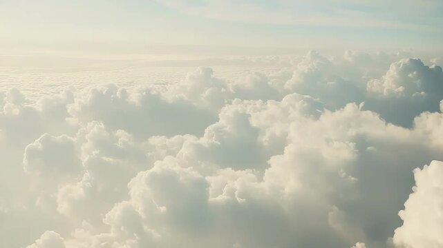 Fluffy white cumulus clouds creating a serene and expansive aerial landscape, illustrating concepts of freedom, travel, dreams, and atmosphere from above