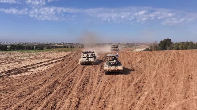 IDF Tanks Maneuvering Near Gaza Border Drone
Drone footage showing Israeli Defense Forces Merkava tanks advancing across sandy terrain near the Gaza border during military operations, 2023.
