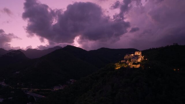 Medieval Fortress Of Arechi Castle At Night Overlooking The City Of Salerno In Italy - Drone Shot