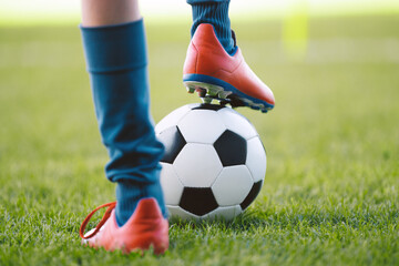 Obraz premium Soccer Ball Control Close-Up. Football Player Practicing Footwork and Balance on Grass Field During Training