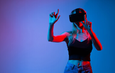 Woman exploring virtual environment with VR headset and gesture control, immersive digital...