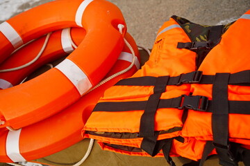An orange lifebuoy. An orange life jacket. © Vladimir