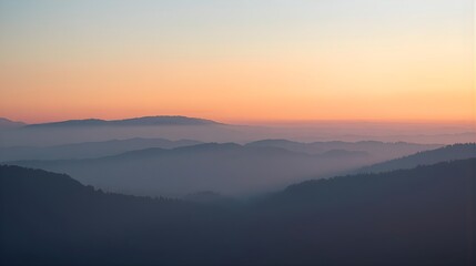 Fototapeta premium Foggy mountain range at sunrise with layered silhouettes, soft pastel sky and mist, calm cinematic nature background, minimalist landscape photography