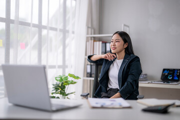 Confident businesswoman relaxing in modern office