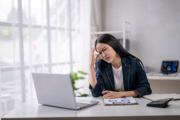 Businesswoman experiencing stress at work desk
