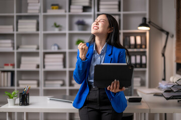 Young professional celebrating success in office