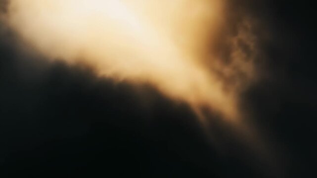 Golden sunbeams pierce dark storm clouds, casting warm, ethereal light that symbolizes hope, spiritual clarity, and a dramatic breakthrough from shadow into brightness