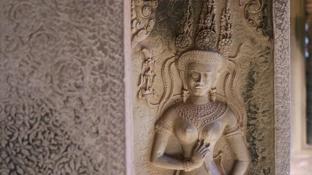 SIEM REAP, CAMBODIA - OCTOBER 27, 2025: Interior view of the ancient stone corridors and galleries within Angkor Wat. Featuring rows of weathered pillars, traditional Khmer window balusters, and the a