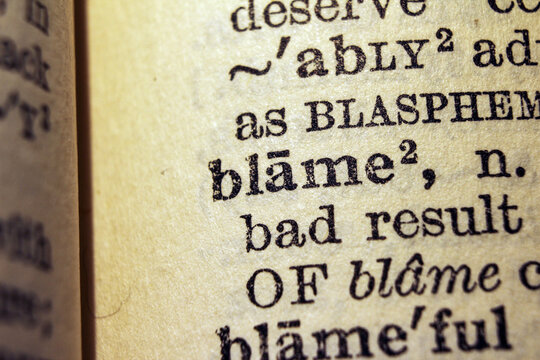 Word blame printed on dictionary page, macro close up
