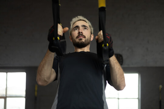Man working out at the gym with training equipment