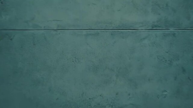 Plain concrete wall with a floor creating a minimalist background, ideal for product display, architectural concepts, or text overlay with ample copy space