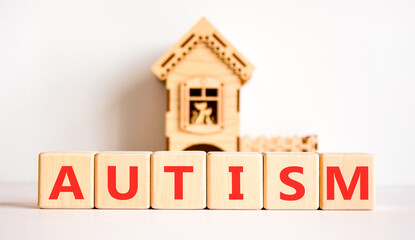 Autism medical symbol. Concept word Autism on beautiful wooden blocks. Beautiful white background....