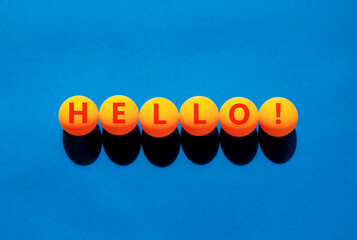 Hello welcome support and help symbol. Concept word Hello on beautiful orange table tennis ping...
