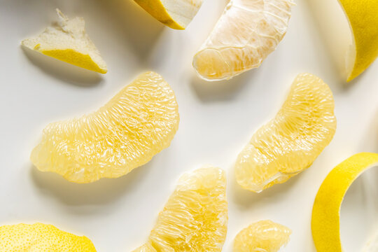 Fresh Chinese grapefruit slices on white background