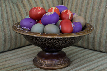 Colorful Easter eggs in a decorative bowl