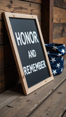 Honor and remember are displayed on framed sign against wooden background, evoking sense of respect and nostalgia