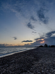 Sunset over pebble beach near Nea Moudania, Greece