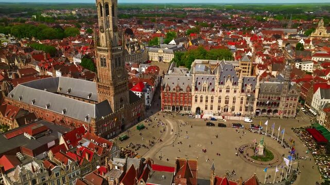 Aerial view of Bruges with historic Markt square and the Belfry Tower surrounder a sunny day