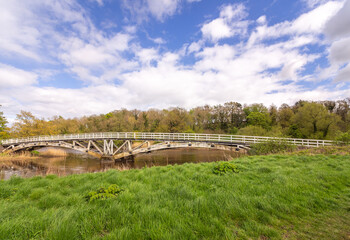 Fototapeta premium Old wooden packhorse bridge spanning the river weaver, Cheshire, UK