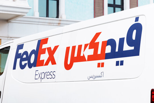 30 November 2025, Doha, Qatar: Logistics van with international FedEx delivery branding, featuring both Latin and Arabic script