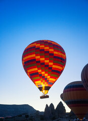 Obraz premium Flaming Ignition And Ascent Of Hot Air Balloons In Cappadocia Turkey