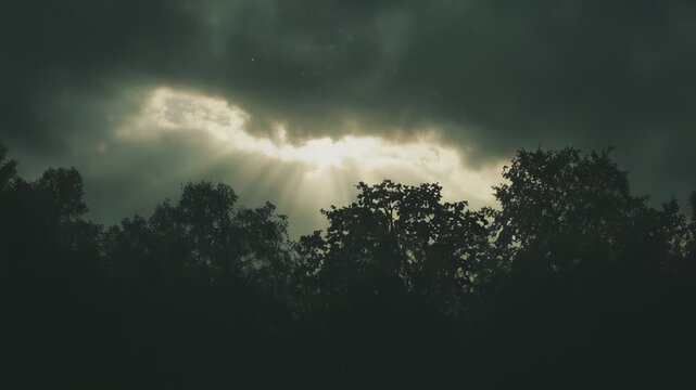 Heavenly light beams shining through a gap in menacing storm clouds, creating a powerful spiritual scene symbolizing hope, new beginnings, guidance, and breakthrough