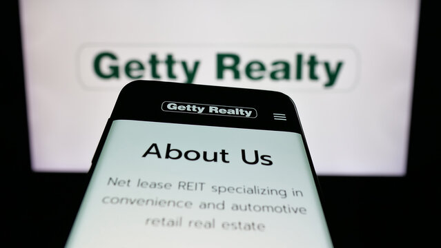 Stuttgart, Germany - 01-15-2026: Mobile phone with website of US real estate company Getty Realty Corp. on screen in front of logo. Focus on top-left of phone display.