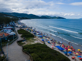 Aerial View of Crowded Beach in Garopaba with Mountains and Atlantic Ocean