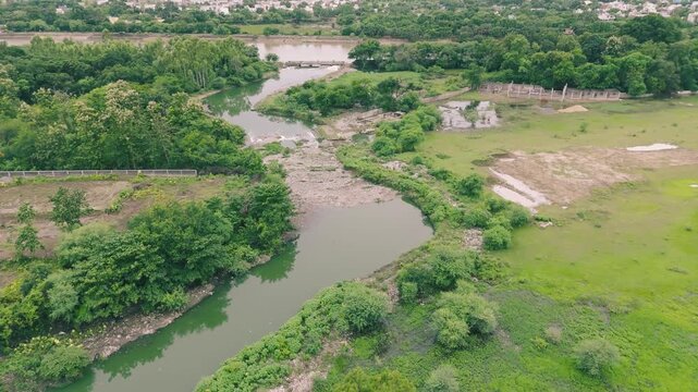 Raipur Polluted river landscape, Garbage filled river view, Contaminated waterway aerial, Environmental pollution river, Waste polluted river scene stock video.