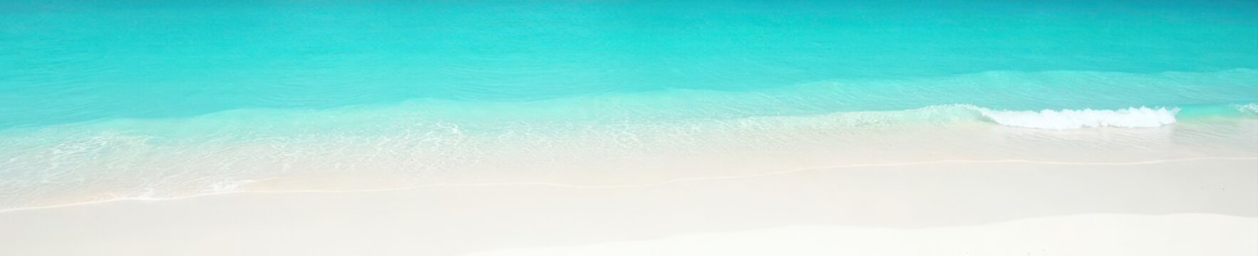 Shallow turquoise water laps gently on white sand , calm, natural, water