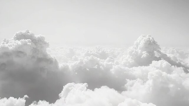 White fluffy cumulus clouds extend across the vast sky, creating a peaceful and pure aerial view, suggesting themes of freedom, heaven, and tranquility