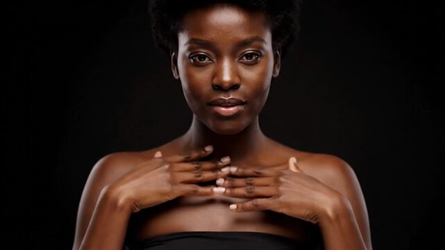 Portrait of a woman with dark skin and a contemplative expression. Her hand touches her neck