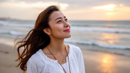 Peaceful Asian woman enjoying the sunset on a beach, gazing at the horizon with a soft breeze 