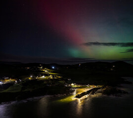 The Aurora Borealis, the northern lights, showing up above Portnoo harbour in County Donegal, Ireland