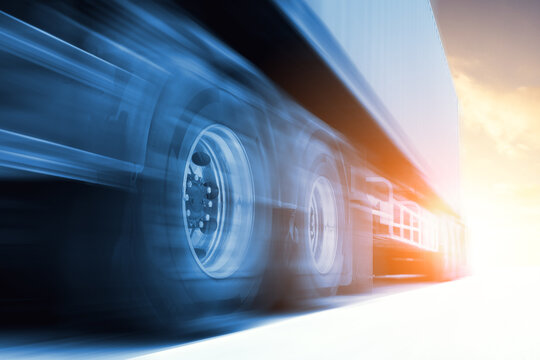 Fast Motion of Semi Trailer Truck Driving on Road. Big rig. Shipping Cargo Container. Economical Transportation Business. Economy Business Transport on Road. Trucking. Truck Logistics.	

