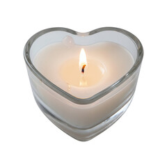 Lit white candle inside heart-shaped glass holder