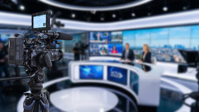 video camera in action on news tv studio background