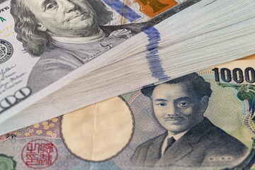 US Dollars Stack On Japanese Yen Bills