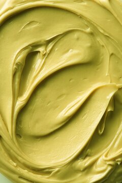 Pistachio smooth cream spread, green color. Full frame. Top view
