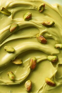 Pistachio cream spread with pistachio nuts over it. Full frame. Top view