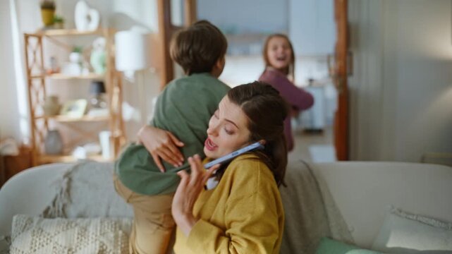 Mother businesswoman working home calming down hyperactive children closeup