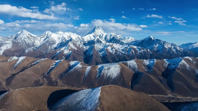 Aerial view of Mount Gongga Summit under blue sky and white clouds