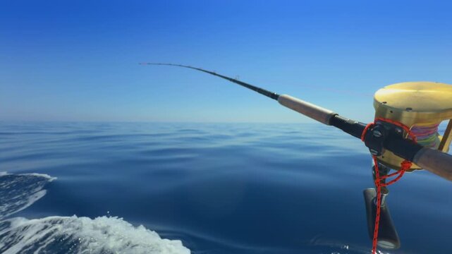 Offshore trolling fishing rod on boat in open sea
