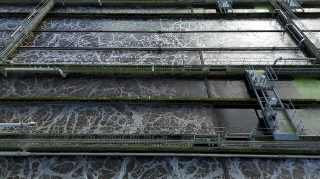 Drone Shot of Wastewater Aeration Basins in United Kingdom, Industrial Bio Filtration Process for Removing Solid Matter in Sewage Works 4K