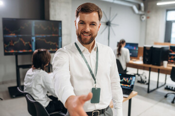 Front view of CEO that is standing and posing. Business people are working with stock market...