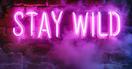 Obraz premium Bright pink neon sign displays Stay Wild against brick wall. Smoke fills bottom portion, creating moody atmosphere.