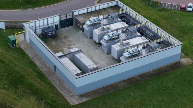 Close up aerial view of high efficiency HVAC cooling units and condensing fans for a modern AI data center in a UK critical infrastructure park.