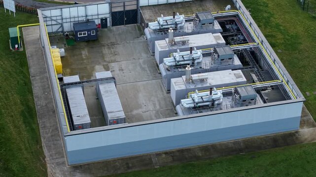 Close up aerial view of high efficiency HVAC cooling units and condensing fans for a modern AI data center in a UK critical infrastructure park.